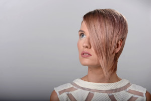Studio portrait of girl with hair over her eye pink